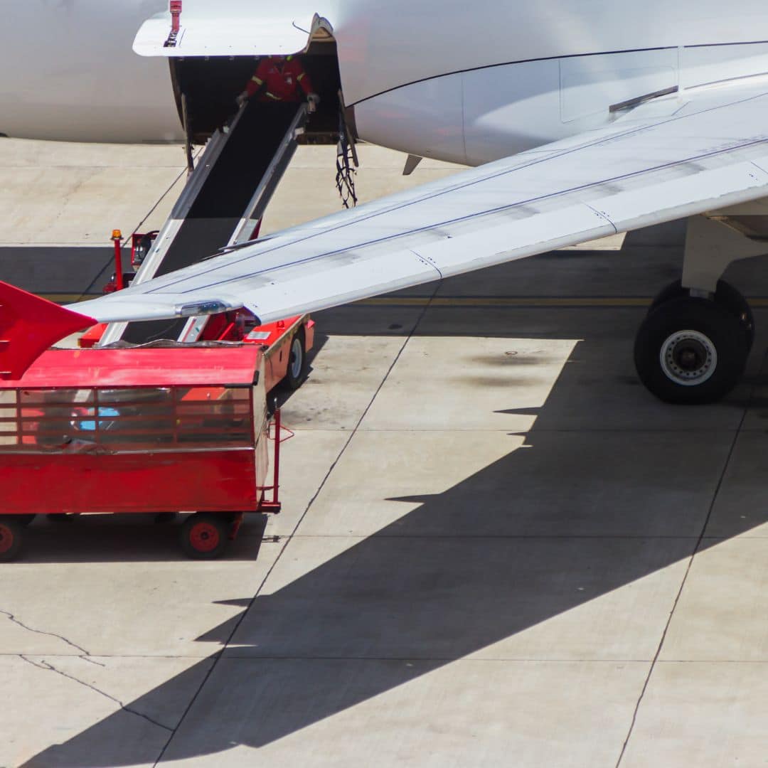 An image of a conveyer belt loding cargo onto an airplane. An example of intermodal freight transport.