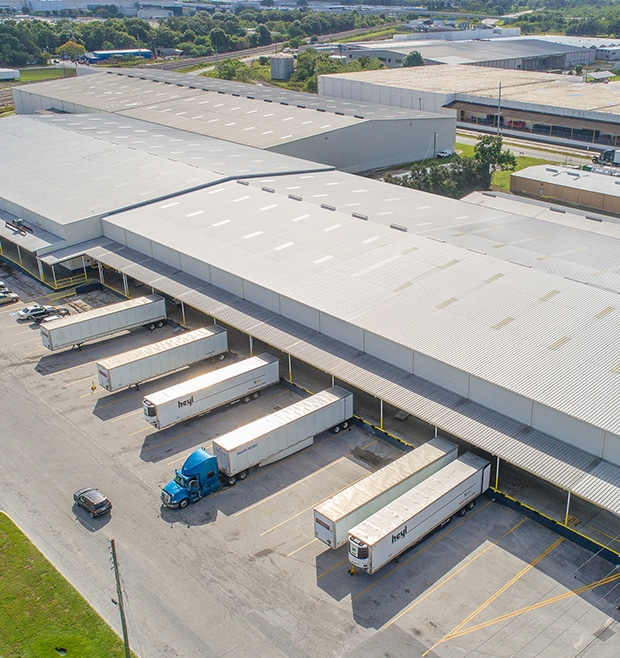 Why choose CWI for Contract Warehousing? Picture of a CWI warehouse with trucks docked.