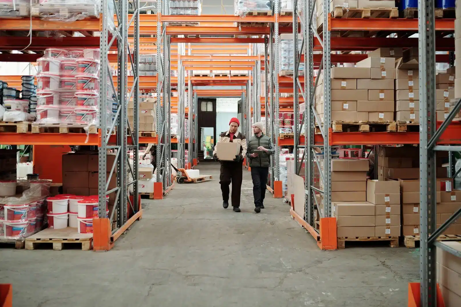 Experienced warehouse staff reviewing inventory together on the floor